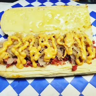 a hot dog covered in mustard