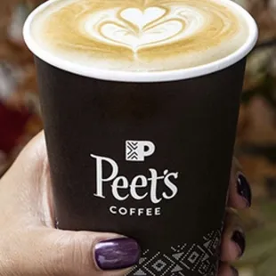 a person holding a cup of coffee