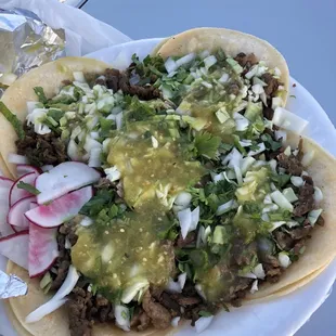 Plate covered in 5 tacos...