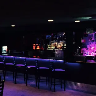 a bar with purple lighting