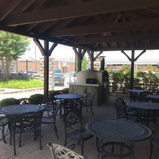 Sitting area outside with pizza brick oven