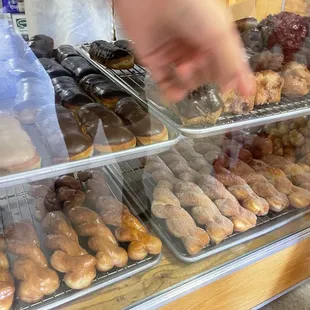 a person reaching for a donut