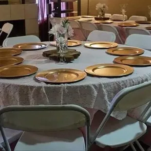 Round Tables, Chairs, Linens, and Lace Overlays.