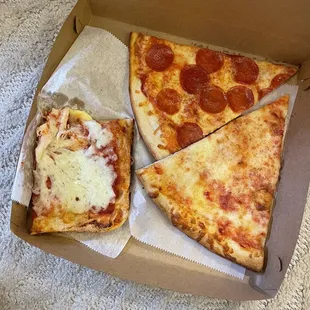 two slices of pizza in a box