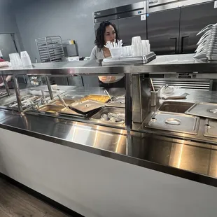 ows a woman serving food at a restaurant