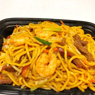 a plate of noodles and shrimp