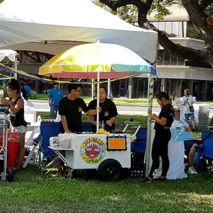 a group of people standing under a tent