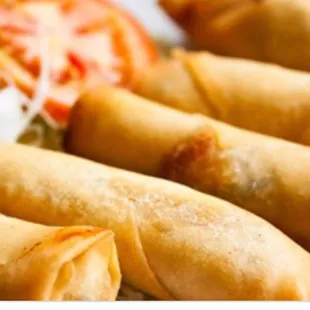 a plate of fried spring rolls