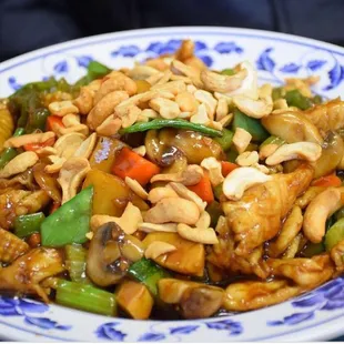 a plate of stir fried vegetables and cashews
