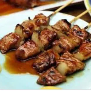a plate of skewered meat