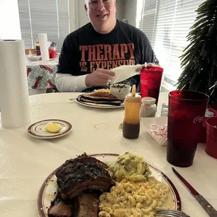 BBQ ribs, brisket, sausage, Mac n Cheese, potato salad, and greens
