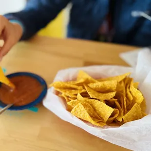 a plate of chips and a bowl of salsa