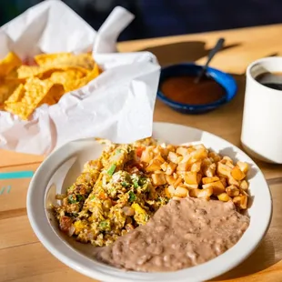 a plate of mexican food and a cup of coffee