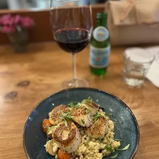 Scallops specials with a glass of wine and Pellegrino.
