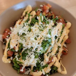 a bowl of pasta with cheese and spinach