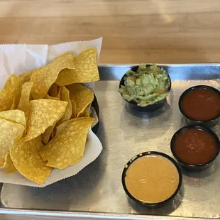 Chips salsa , guacamole, smoked queso