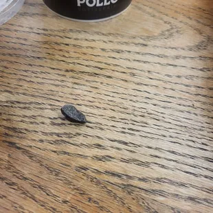 Half chicken meal with beans and potatoes salad and a rock