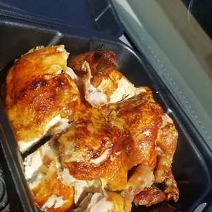 a roast chicken in a roasting pan