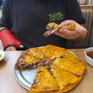 a man eating a quesadilla