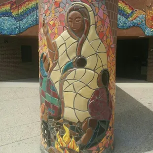 Pole outside entrance decorated with tiles.