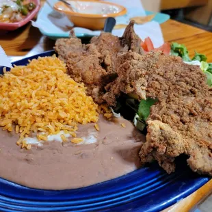 a plate of fried chicken and rice