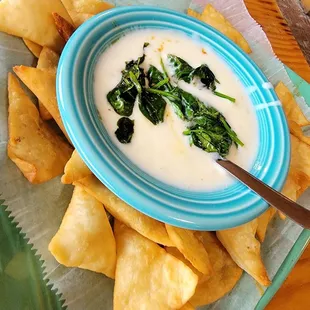 a bowl of dip and tortillas