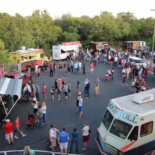a crowd of people standing in a parking lot