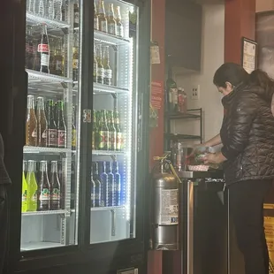 Drinks and fountain drinks! This gal is making a Michilada!