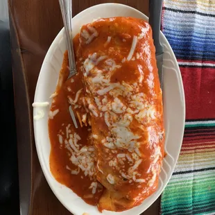 Al pastor wet burrito with red salsa. Such a masterpiece of a photo belongs in the Louvre