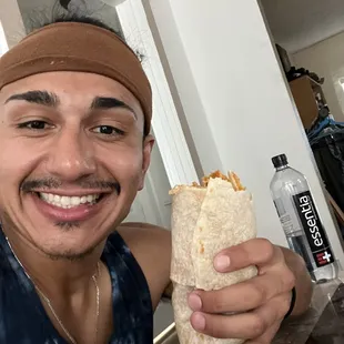 a man holding a burrito