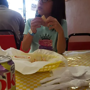 a young girl eating a donut
