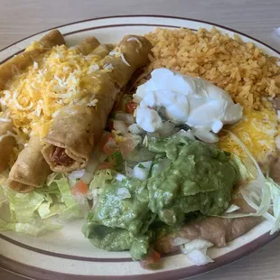 Chicken Tostadas , rice and beans, sour cream, guacamole, plenty of cheese!!!