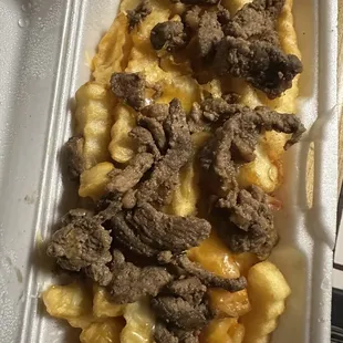 Carne asada fries with shredded cheese. Beans, sour cream and guacamole requested on the side.