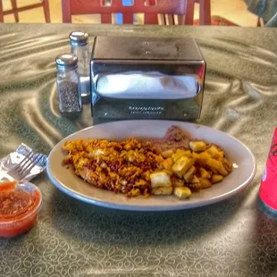 Chorizo (Spanish sausage) con huevo (scrambled eggs), papas (potatoes) y frijoles (refried beans). Coke-Zero! Excellent Salsa.