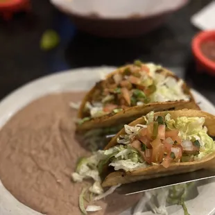 Tacos no cheese ( one shredded beef one ground beef). Vegan refried beans.