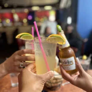two people toasting with drinks