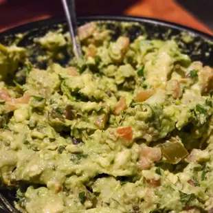 Fresh guacamole made table side.