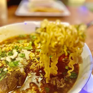 a bowl of soup with noodles and meat