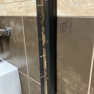 Bathroom stall divider removed but not completely.