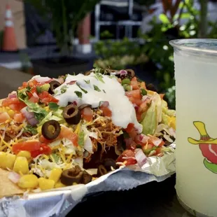 a plate of nachos and a drink