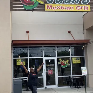 a woman standing in front of a mexican grill