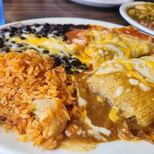 Combo plate with chilled relleno, pork tamales and beef enchilada with rice and black beans