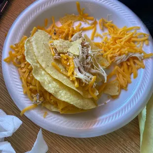 shredded chicken and cheese on a paper plate