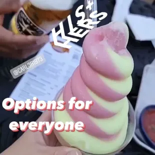 a person holding a cone of ice cream