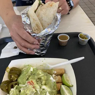 Flautas with lettuce, sour cream, guacamole, jalapeños, lime.