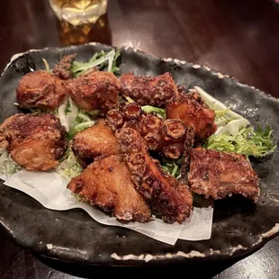 a plate of fried chicken with lettuce