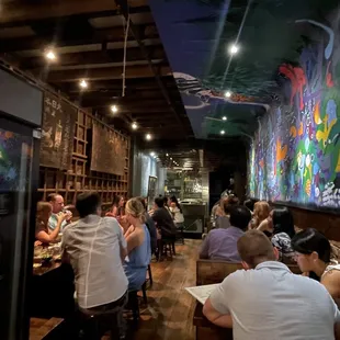 people sitting at tables in a restaurant