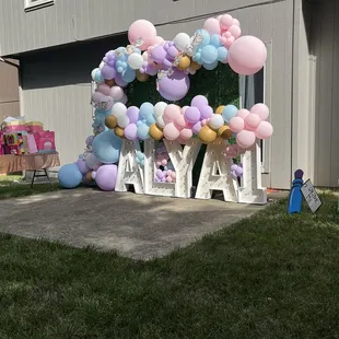 Balloon arches and boxwood backdrop (letters not included)