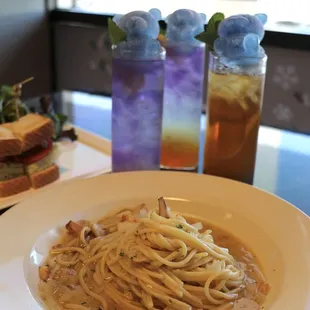a plate of pasta and a sandwich