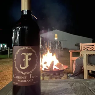 a bottle of wine on a picnic table